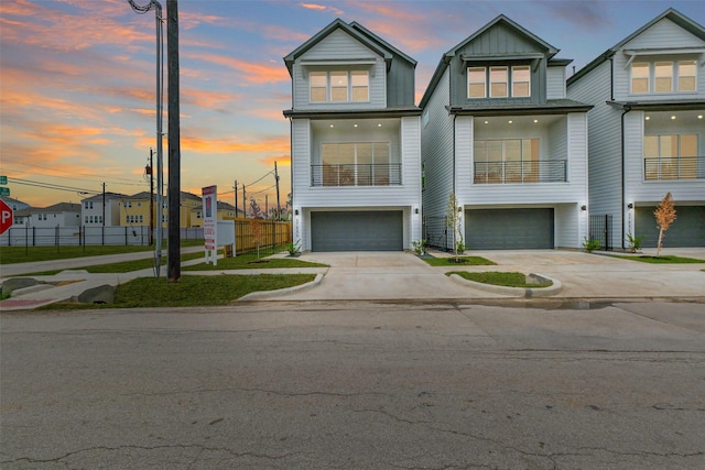 5703 Balbo St Unit E, Houston, TX 77091 - view of front of home with a garage, concrete driveway, fence, and board and batten siding