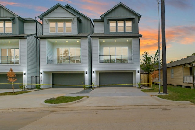 view of front of house featuring an attached garage, board and batten siding, and concrete driveway