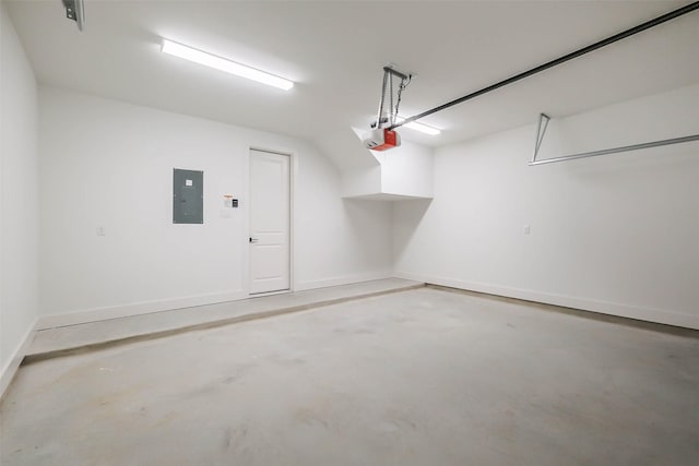 garage featuring a garage door opener, electric panel, and baseboards