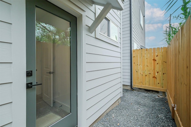 entrance to property with a garage and fence