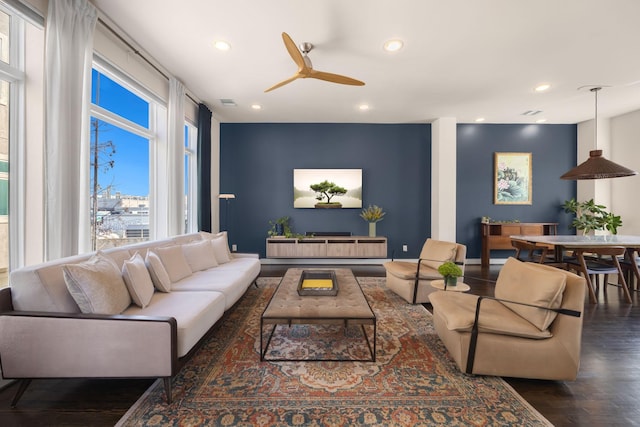 living room with ceiling fan, visible vents, dark wood-type flooring, and recessed lighting