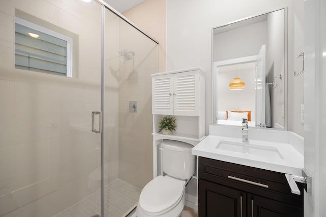 bathroom featuring a shower stall, toilet, and vanity