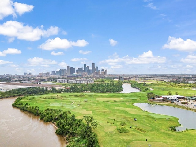 birds eye view of property featuring golf course view, a water view, and a city view