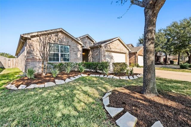 view of front facade featuring brick siding, a front yard, driveway, and a garage