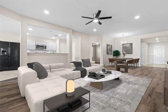 living room featuring recessed lighting, ceiling fan, and wood finished floors