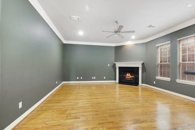 unfurnished living room featuring baseboards, visible vents, and a tiled fireplace