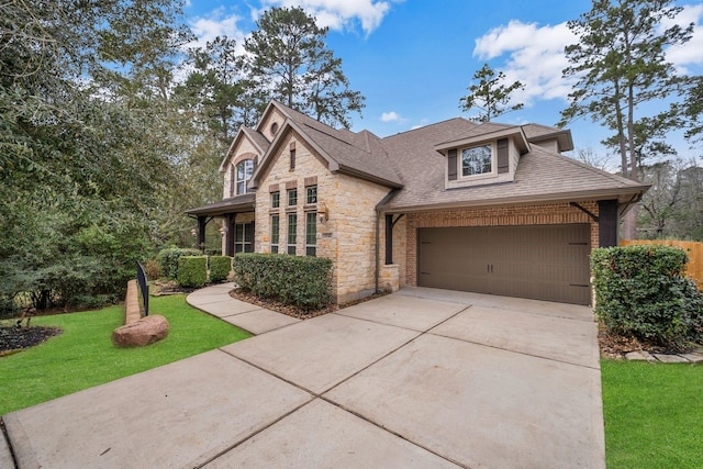 view of front of home with driveway, a garage, stone siding, roof with shingles, and a front lawn