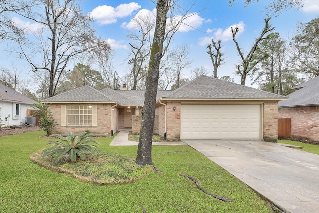 single story home with a front lawn, central AC unit, and a garage