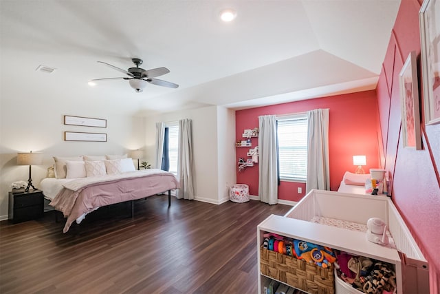 bedroom with a ceiling fan, dark wood-style flooring, multiple windows, and baseboards