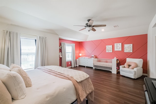 bedroom featuring dark wood-style floors, visible vents, and a ceiling fan