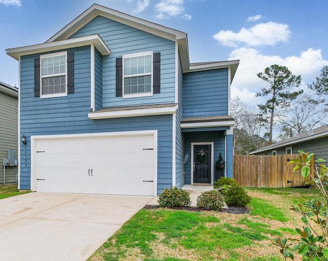 traditional home featuring a garage, a front yard, fence, and driveway