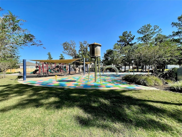 view of home's community with a lawn and playground community