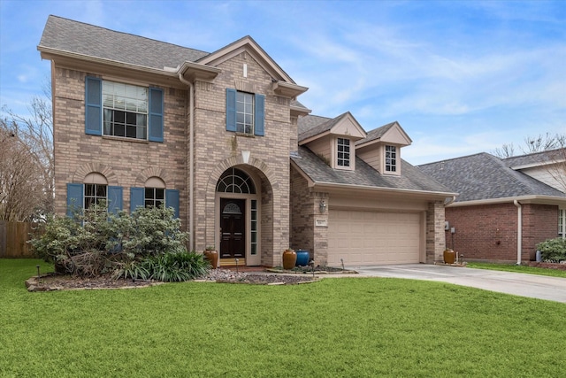 view of front of house featuring brick siding, driveway, and a front lawn