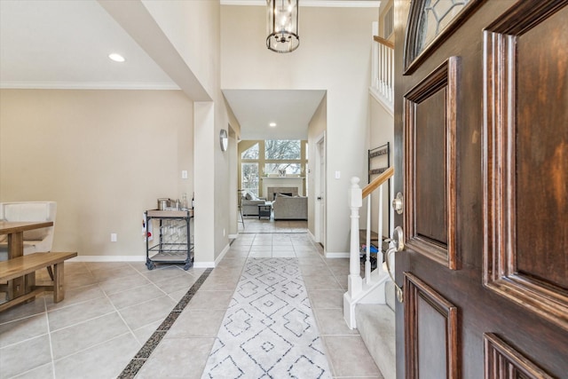 entrance foyer featuring recessed lighting, baseboards, ornamental molding, and light tile patterned flooring