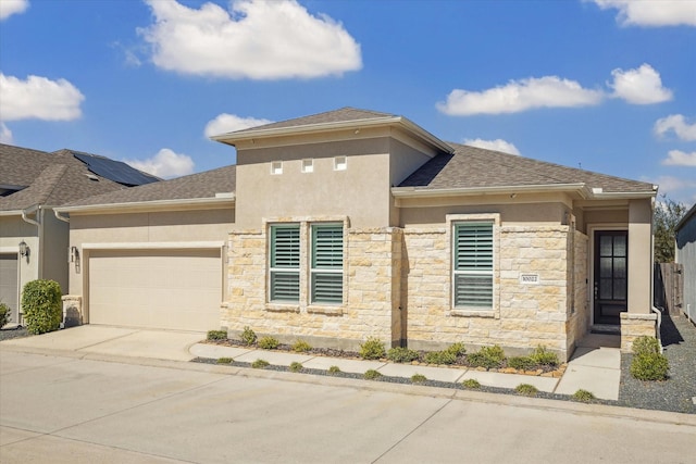 prairie-style house featuring a garage, a shingled roof, concrete driveway, stone siding, and stucco siding