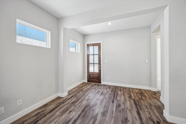 entryway with baseboards and wood finished floors