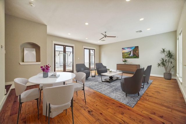 dining space featuring light wood-type flooring, french doors, and ceiling fan