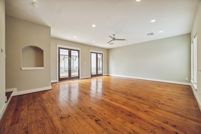 unfurnished living room with hardwood / wood-style floors, french doors, and ceiling fan