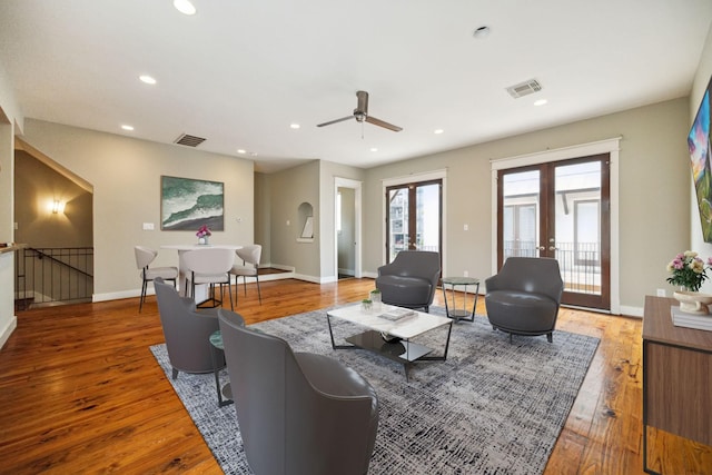 living room with wood-type flooring and french doors