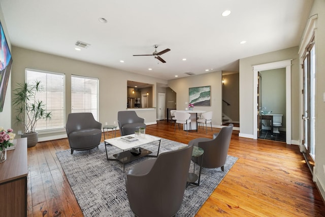 living room featuring ceiling fan and wood-type flooring