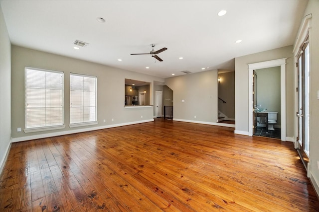 unfurnished living room featuring light hardwood / wood-style flooring and ceiling fan