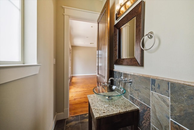 bathroom featuring tile walls and vanity