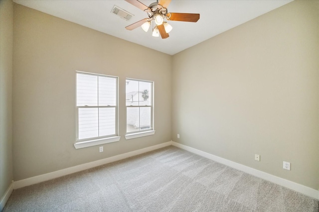 empty room with ceiling fan and carpet floors