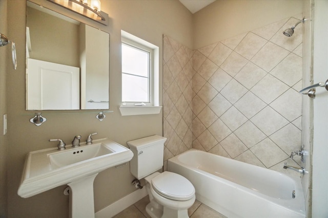 bathroom featuring tiled shower / bath combo, tile patterned flooring, and toilet