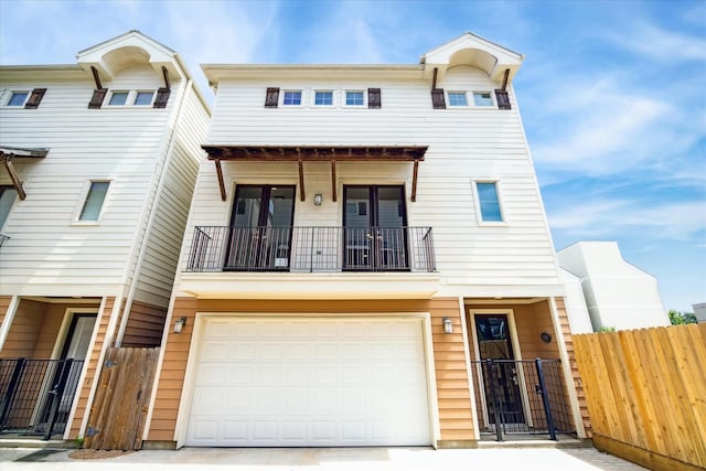 view of property with a garage and a balcony