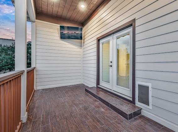 exterior entry at dusk featuring french doors