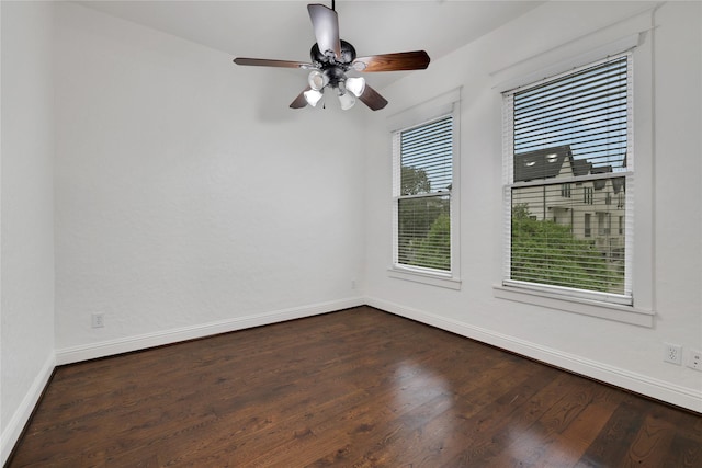 spare room featuring dark wood-type flooring and ceiling fan