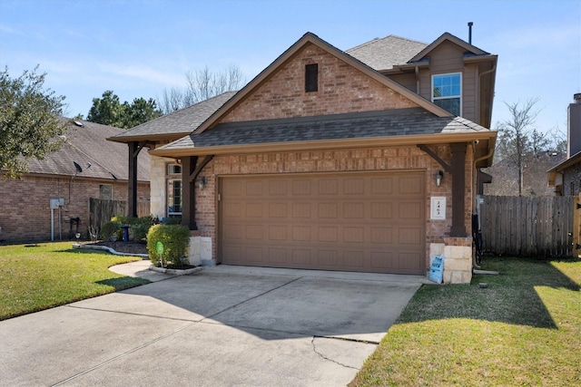 view of front facade with a shingled roof, an attached garage, fence, a front yard, and brick siding