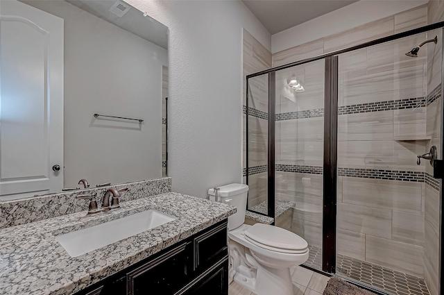 bathroom featuring toilet, vanity, and walk in shower