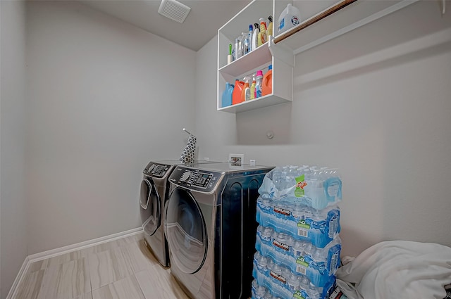 washroom with independent washer and dryer