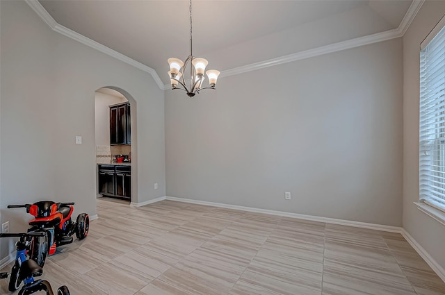 interior space featuring a notable chandelier, ornamental molding, and a wealth of natural light