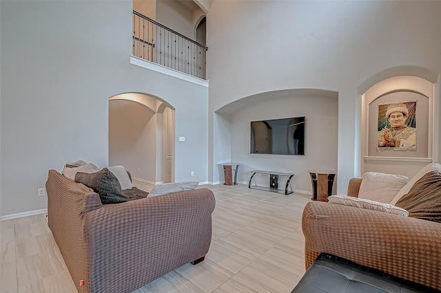 living room featuring a towering ceiling