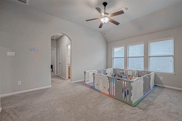 game room with lofted ceiling, light colored carpet, and ceiling fan