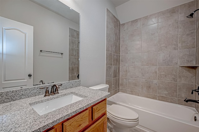 full bathroom featuring tiled shower / bath combo, vanity, and toilet