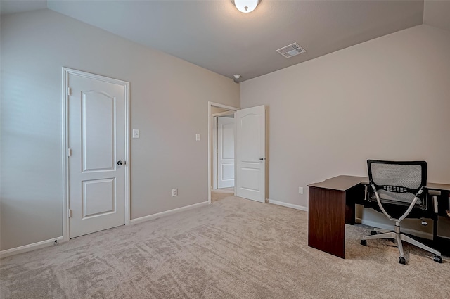 office featuring lofted ceiling and light colored carpet