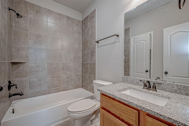 full bathroom featuring toilet, vanity, and tiled shower / bath