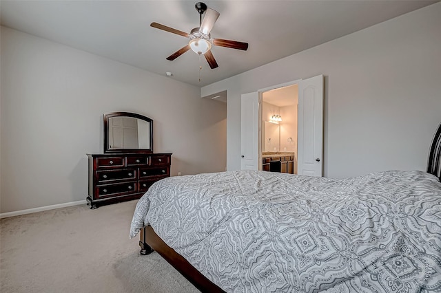 bedroom featuring ceiling fan, connected bathroom, and light colored carpet