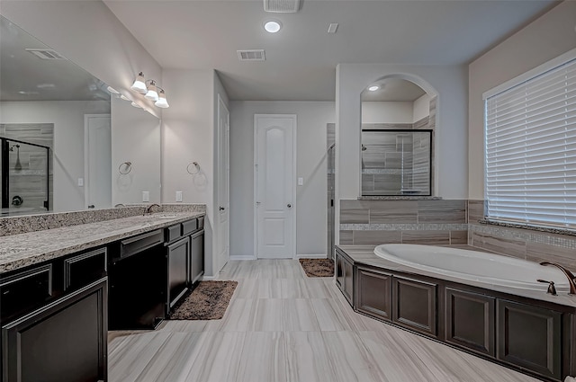 bathroom with plus walk in shower and vanity