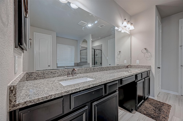 bathroom with vanity and an enclosed shower