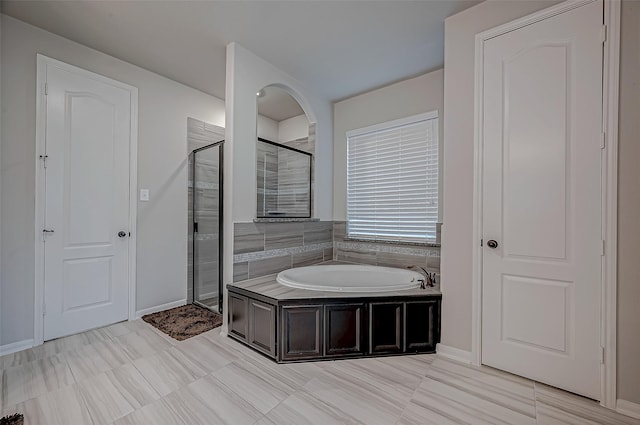 bathroom with shower with separate bathtub