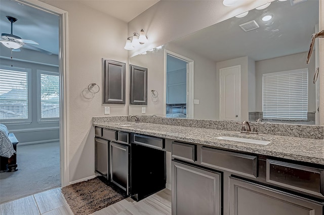 bathroom featuring ceiling fan and vanity