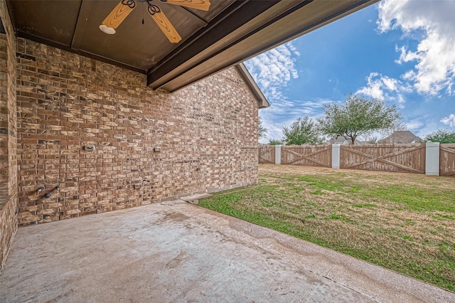 view of yard with ceiling fan and a patio area