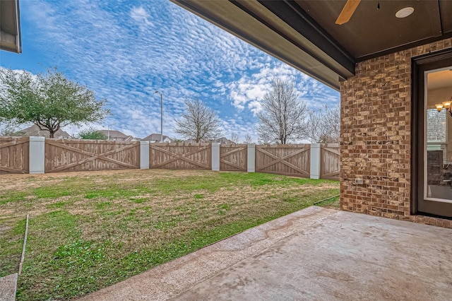 view of yard featuring ceiling fan and a patio area