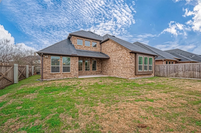 back of property featuring a patio and a yard