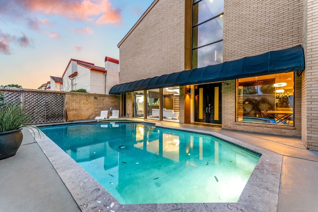 view of swimming pool featuring fence and a fenced in pool