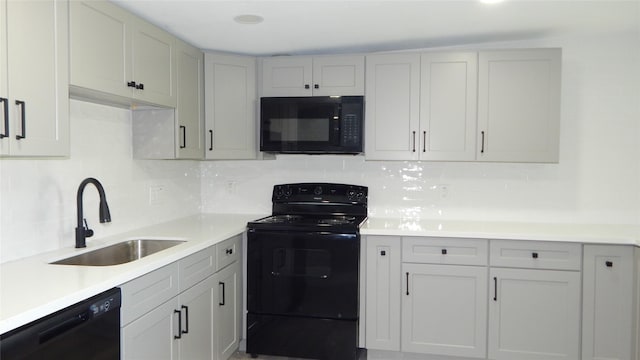 kitchen with decorative backsplash, sink, and black appliances